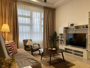 a living room with a couch and a television at Affordable Family Stay in Bangi in Kajang
