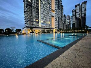 a large swimming pool in front of some tall buildings at Affordable Family Stay in Bangi in Kajang