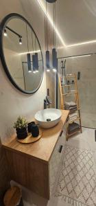 a bathroom with a sink and a large mirror at Domki Dwa jelonki - balia z jacuzzi i sauna in Wisła +29 photos