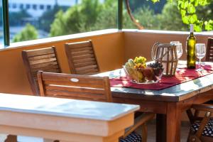 een tafel met een fruitschaal en een fles wijn bij Holiday Home Nina Plitvine in Vela Luka