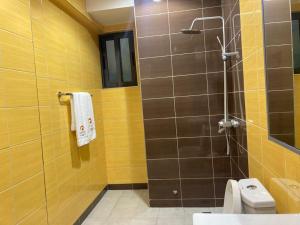 a bathroom with a shower with a toilet and a sink at Cereno Homes Accra in Accra