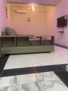 a living room with a couch and a tv at Cereno Homes Accra in Accra
