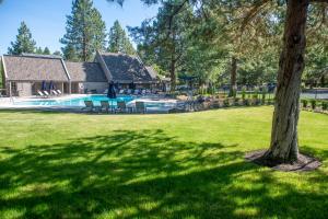 a tree in a yard with a swimming pool at Mt Bachelor Village Resort Condo 19 Mi to Skiing! in Bend