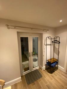 a room with a sliding glass door and a shelf at Petite Jessamine in St Margarets at Cliff