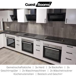 a kitchen with white cabinets and a stove top oven at Unterkunft für 2 - GuestRooms24 - Marl in Marl