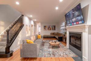 a living room with a fireplace and a tv at Beautiful 5br home for 14 guests with free parking in Chicago