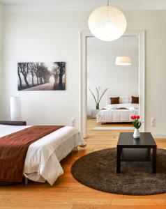 a bedroom with two beds and a large mirror at Basilica City Apartments in Budapest