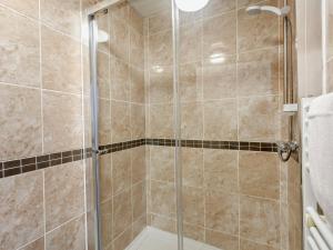 a shower with a glass door in a bathroom at 2 bed property in Bath 37147 in Chew Magna