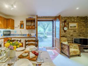 a kitchen with a table and a dining room at 2 Bed in Sedbergh 57641 in Dent