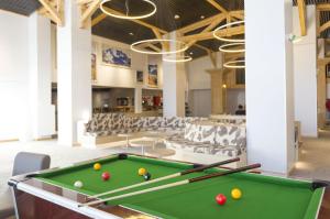 a pool table in the middle of a room at Hôtel Club mmv Les Arolles **** in Val Thorens