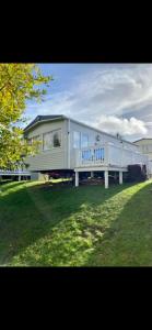 a modern home with a trailer in a yard at Laguna- Rockley Park Poole in Poole