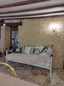 a bed in a room with a stone wall at Stargazer Studio in Saint-Chamassy +27 photos