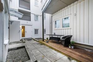 a patio with a table and chairs next to a building at Hidden gem near the Old Town Bridge, 40m² apt. in Trondheim
