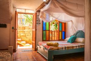 a bedroom with a bed with a canopy at Hotel Casa Blanca Barichara By MH in Barichara