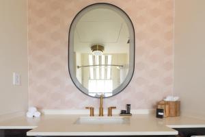 a bathroom with a sink and a mirror at La Concha Key West in Key West