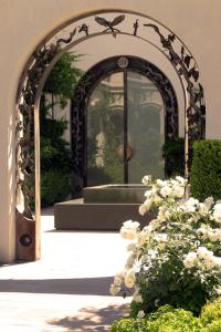 an archway with a fountain in front of a building at Susana Balbo Winemaker´s House in Ciudad Lujan de Cuyo
