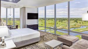 a hotel room with a bed and a large window at Mystic Lake Casino Hotel in Prior Lake