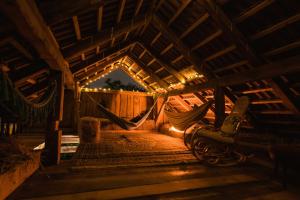 an attic room with a hammock in it at night at Hay barn unique experience Visole in Slovenska Bistrica