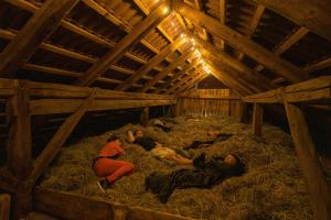 a group of people laying in hay in a barn at Hay barn unique experience Visole in Slovenska Bistrica