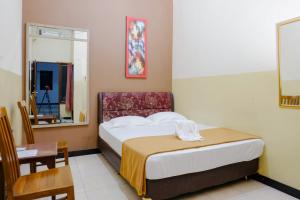 Postel nebo postele na pokoji v ubytování Dya Hotel Boyolali