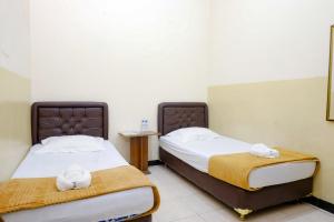 Postel nebo postele na pokoji v ubytování Dya Hotel Boyolali