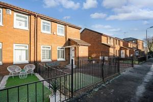 a wrought iron fence in front of a house at Stylish 2-Bed House Private Driveway in Glasgow