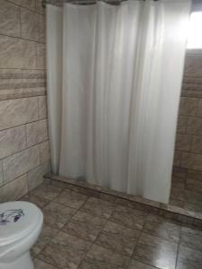 a bathroom with a white shower curtain and a toilet at Khachik White Canyon in Khachʼik