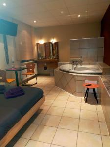 a large bathroom with a tub and a sink at Love Paradise by Karen's Room Service in Forbach