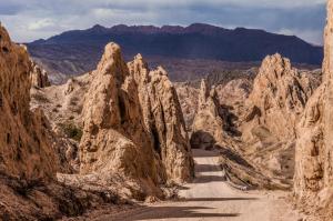 a dirt road through a canyon with mountains at Patios De Cafayate in Cafayate