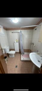 a bathroom with a toilet and a sink at Akrotiri studios in Samothráki