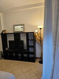 a black entertainment center with a flat screen tv at Divina House in Marino