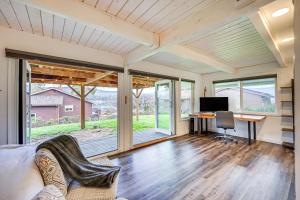 an empty living room with a desk and a computer at Stylish Bellingham Home with Lake and Mountain Views! in Bellingham