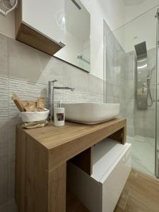 a bathroom with a sink and a glass shower at Apulia White House 59 in Bari +51 photos
