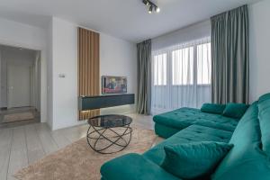 布拉索夫Aly Residence的客厅里有一张绿色的沙发和一张桌子