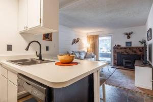 a kitchen with a sink and a bowl on a counter at Cozy Cabin-Style Condo in Central Location in Mammoth Lakes