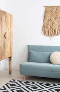 a blue couch in a living room with a rug at Apartamento Nc Beach Home 31-B in Bellreguart +11 photos