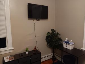 uma sala de estar com uma televisão pendurada na parede em The Top-Floor at Centerdale Village Room B* Private Room em North Providence
