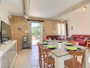 uma cozinha e sala de estar com mesa e cadeiras em Mas de Cachoun em Barbentane