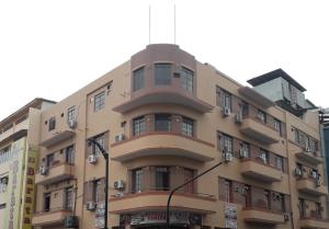 an apartment building with a rounded top at Hotel City Central Guayaquil in Guayaquil