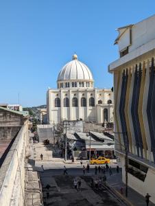 a building with a dome on top of a city at Hotel Abrego in San Salvador