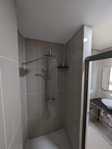 a shower with a glass door in a bathroom at Hotel Abrego in San Salvador