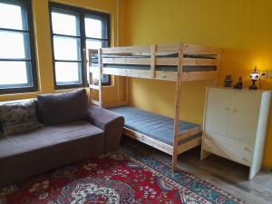 a living room with a bunk bed and a couch at Esztergomi Galagonyás Ház in Esztergom