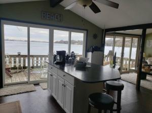 a kitchen with a counter with a view of the ocean at West Lake Waterfront Swimming - Free Pontoon Boat! in West Lake