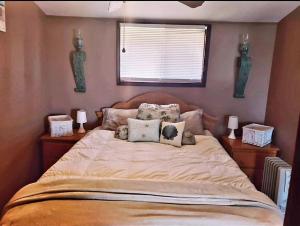 a bedroom with a large bed with pillows on it at West Lake Waterfront Swimming - Free Pontoon Boat! in West Lake