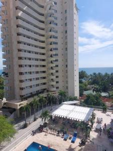 uma vista panorâmica de um grande edifício com piscina em Espectacular apartamento Santa Marta se debe reservar almenos un día antes de llegar al apartamento em Santa Marta