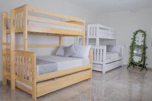 a bedroom with two bunk beds and a couch at Casa de campo Huachipa in Lima