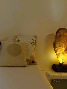 a bedroom with a bed with a pillow and a lamp at Errika's Sweet Home in Provatas