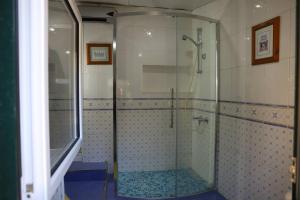a shower with a glass door in a bathroom at Refúgio Saloio- LugarTranquilo às Portas de Lisboa in Lousa +29 photos