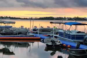 a group of boats are docked at a dock at Westlake Dunes View Beach-FREE Pontoon Boat Rental in West Lake
