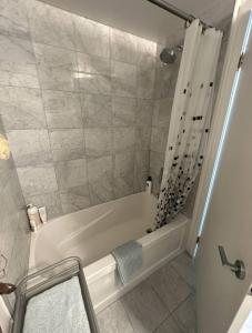 a bathroom with a white tub and a shower at to be deleted in Toronto